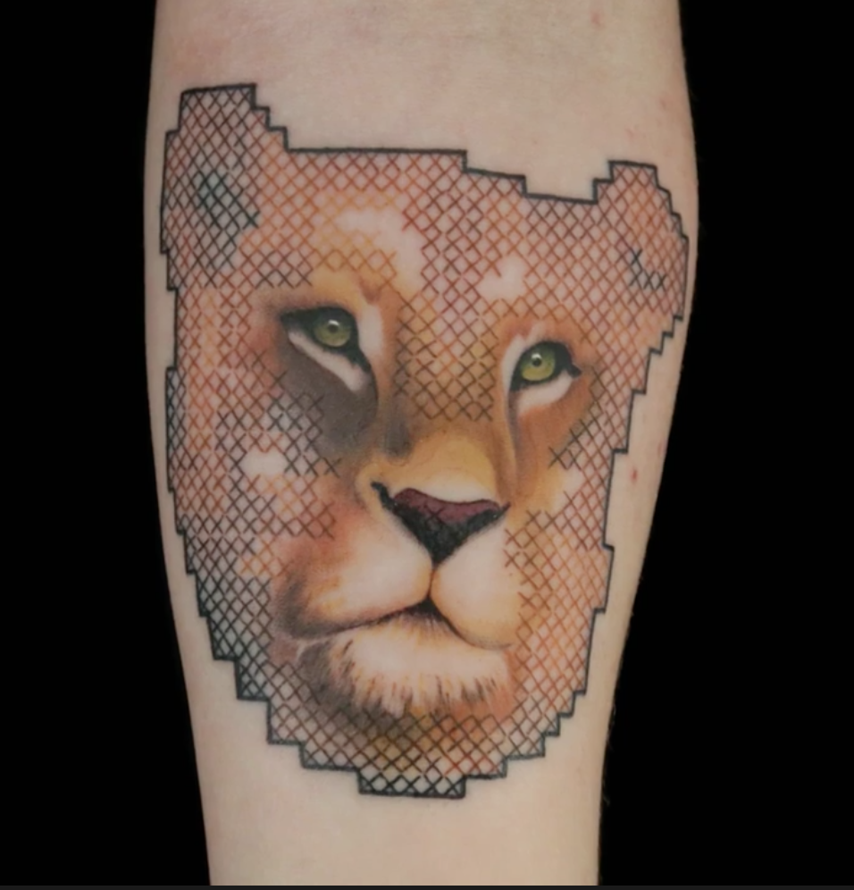 Janelle Hanson cross-stitch lion tattoo