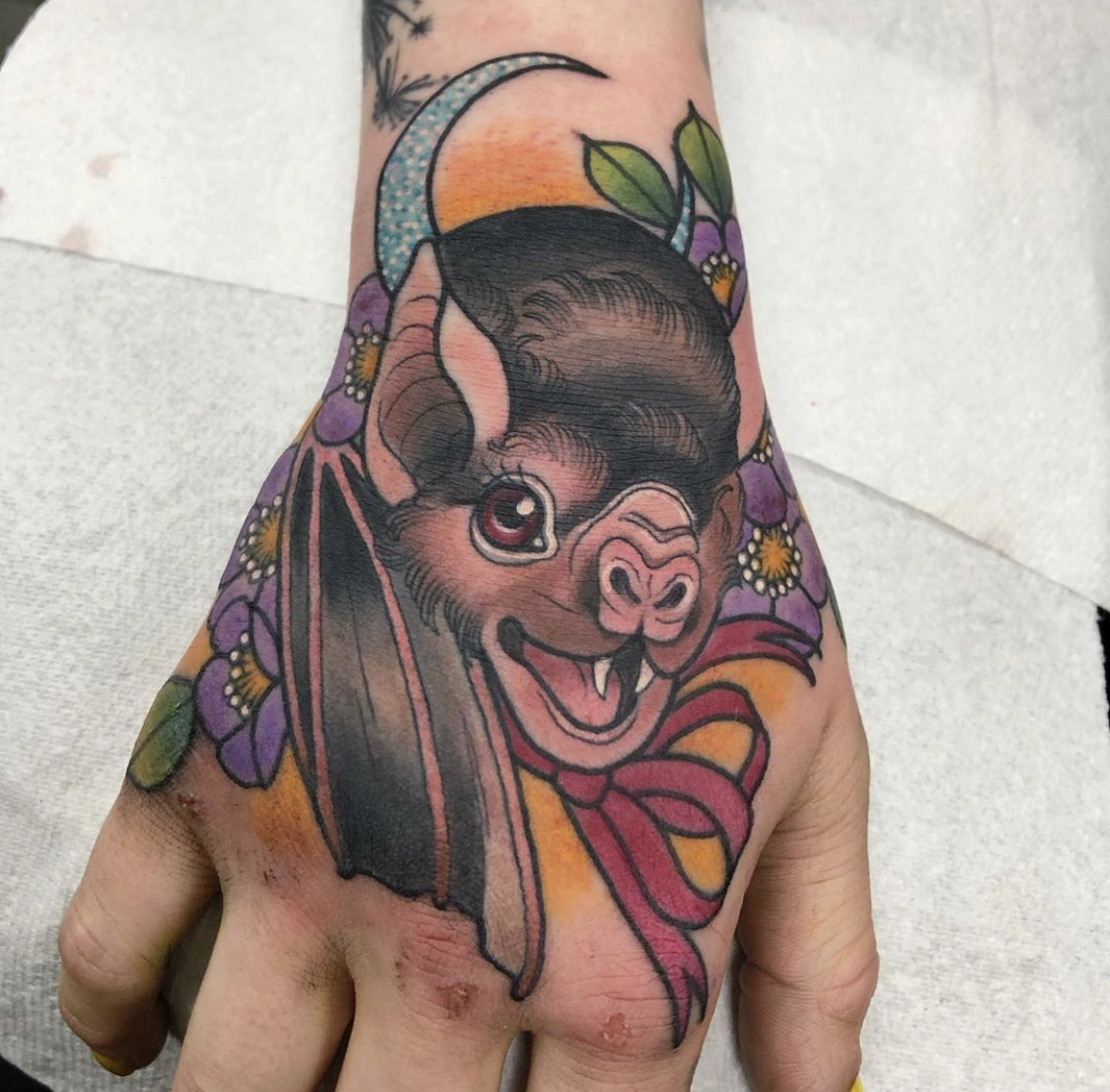 Tattoo of bat on hand