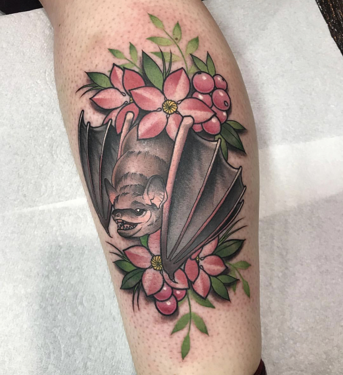 Bat tattoo with flowers