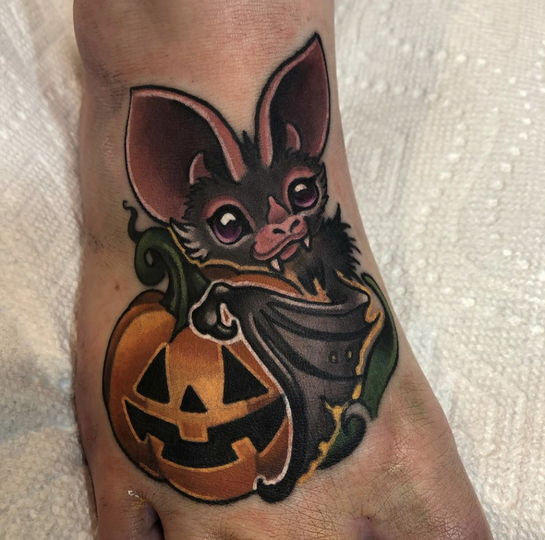 Bat and pumpkin tattoo