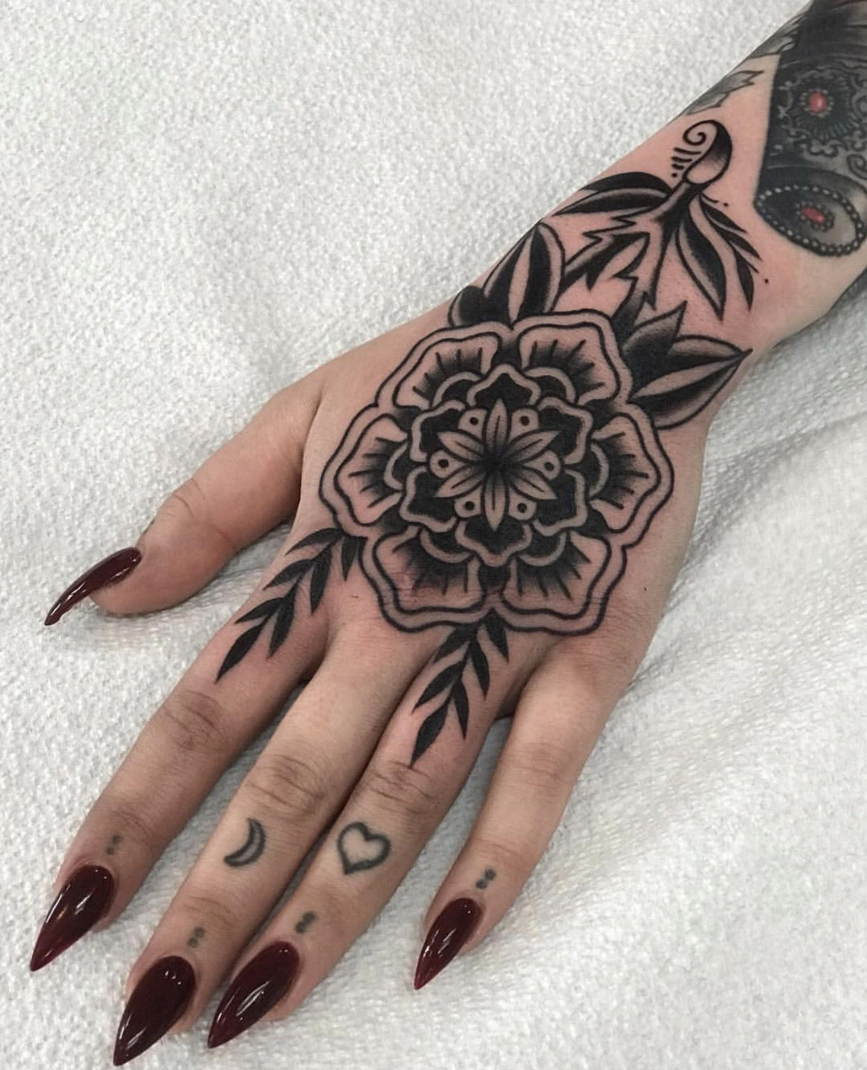 Blackwork hand tattoo by Tasha Tonks