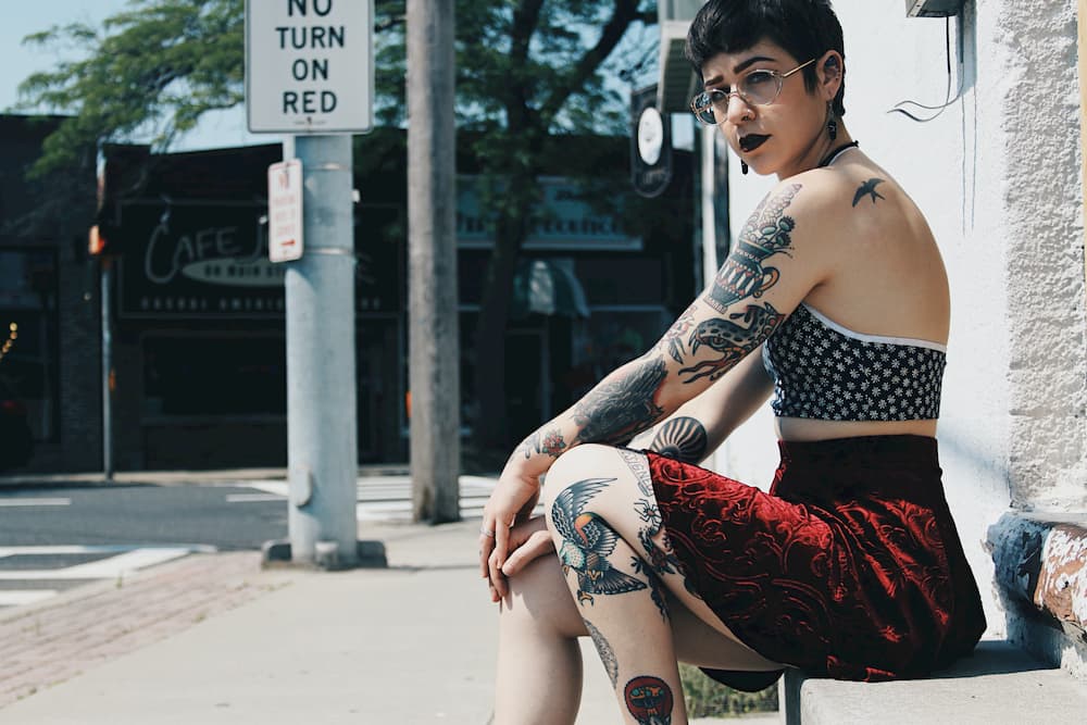 Tattooed woman sitting outside