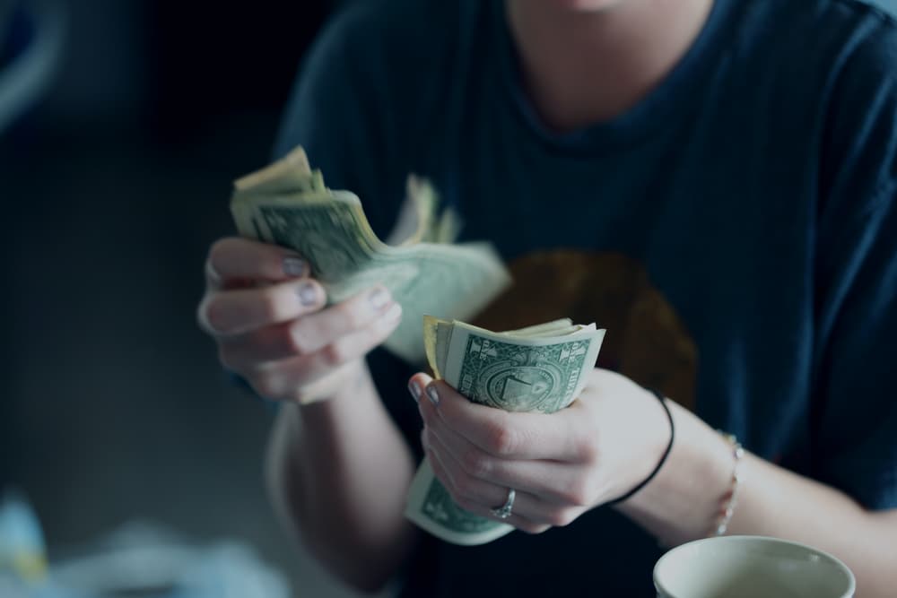 Counting money for a tattoo artist tip