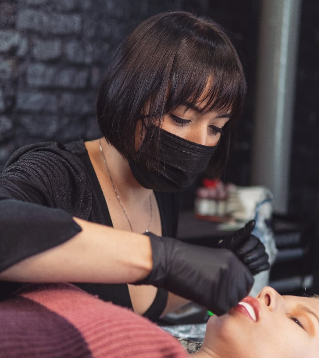 Savannah Kondratyev doing a lip blush tattoo.